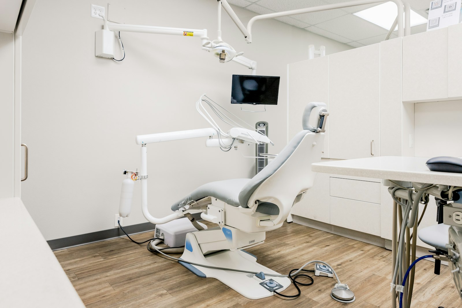 An empty dental operatory chair and equipment