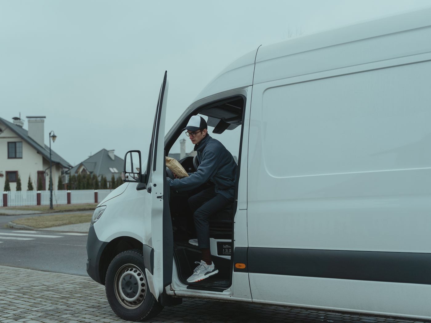 A delivery driver at a residential doorstep
