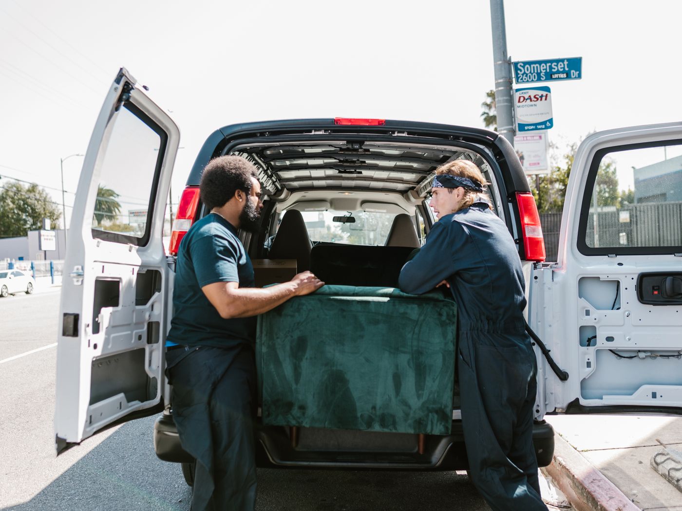 Movers carrying boxes into a truck