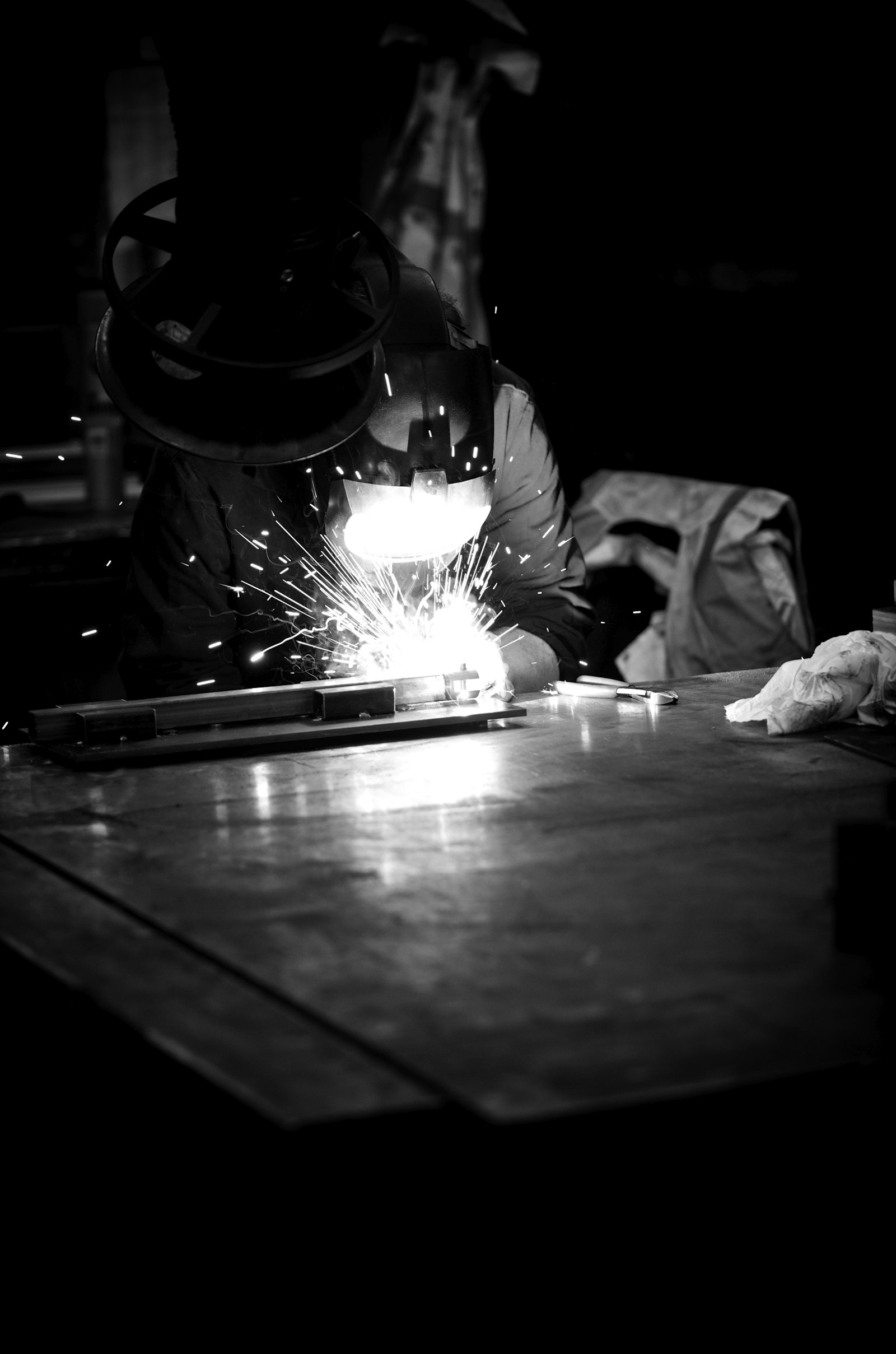 A welder joining metal, with sparks flying