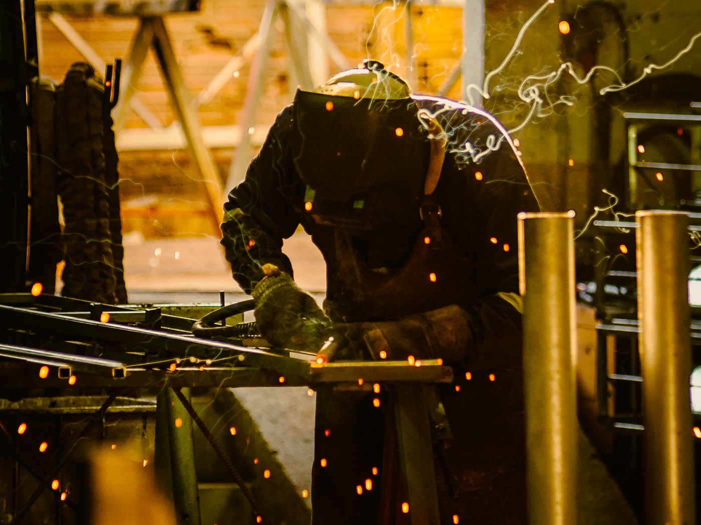 A welder joining steel, sparks flying