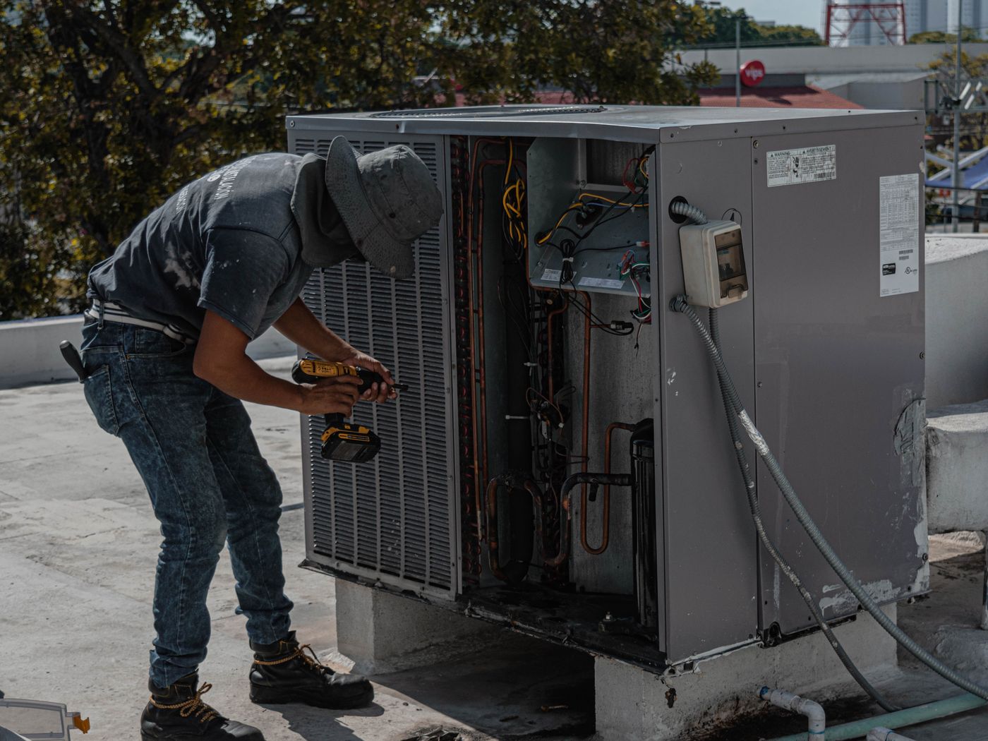 A rooftop HVAC unit being serviced