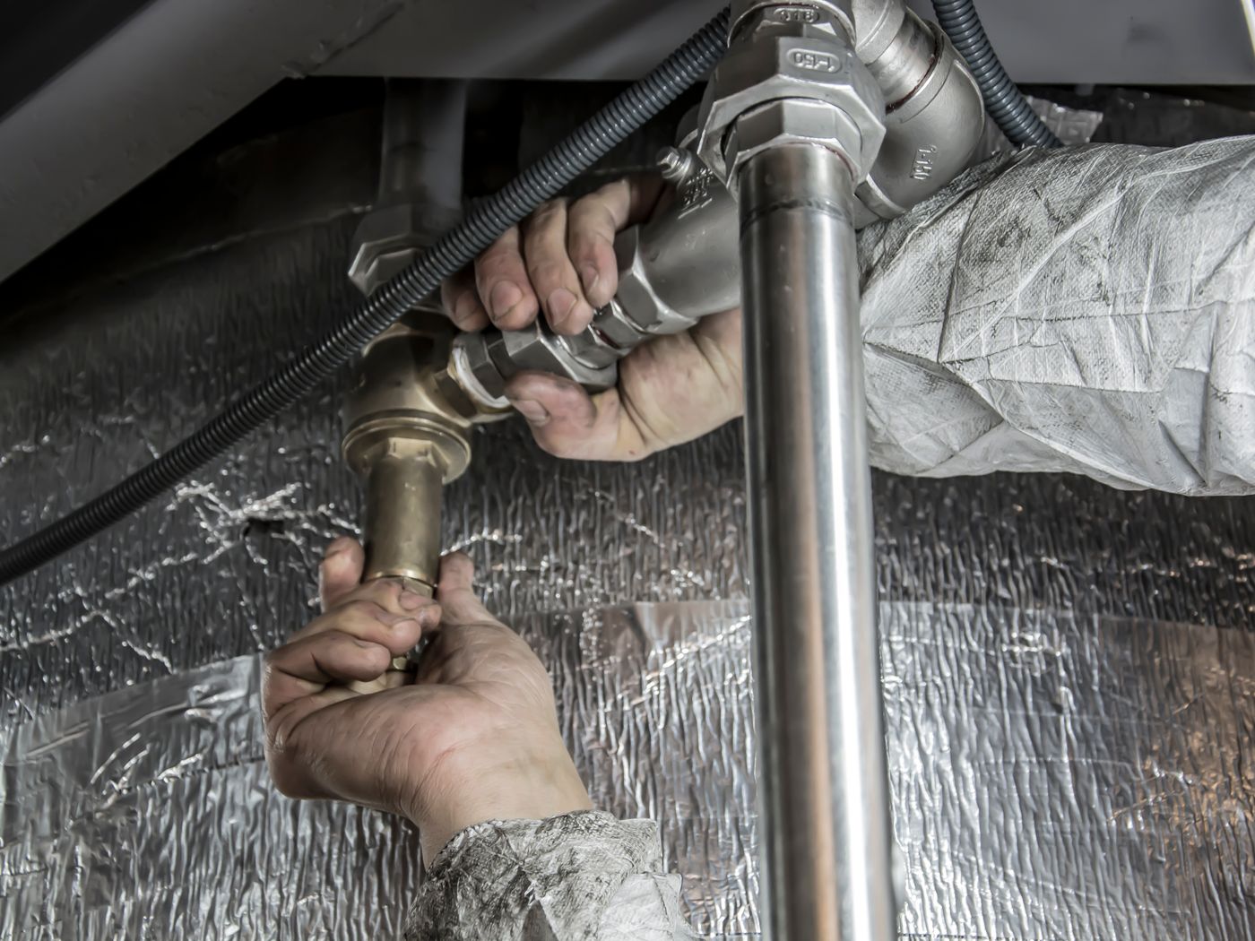 A plumber fitting pipe by hand