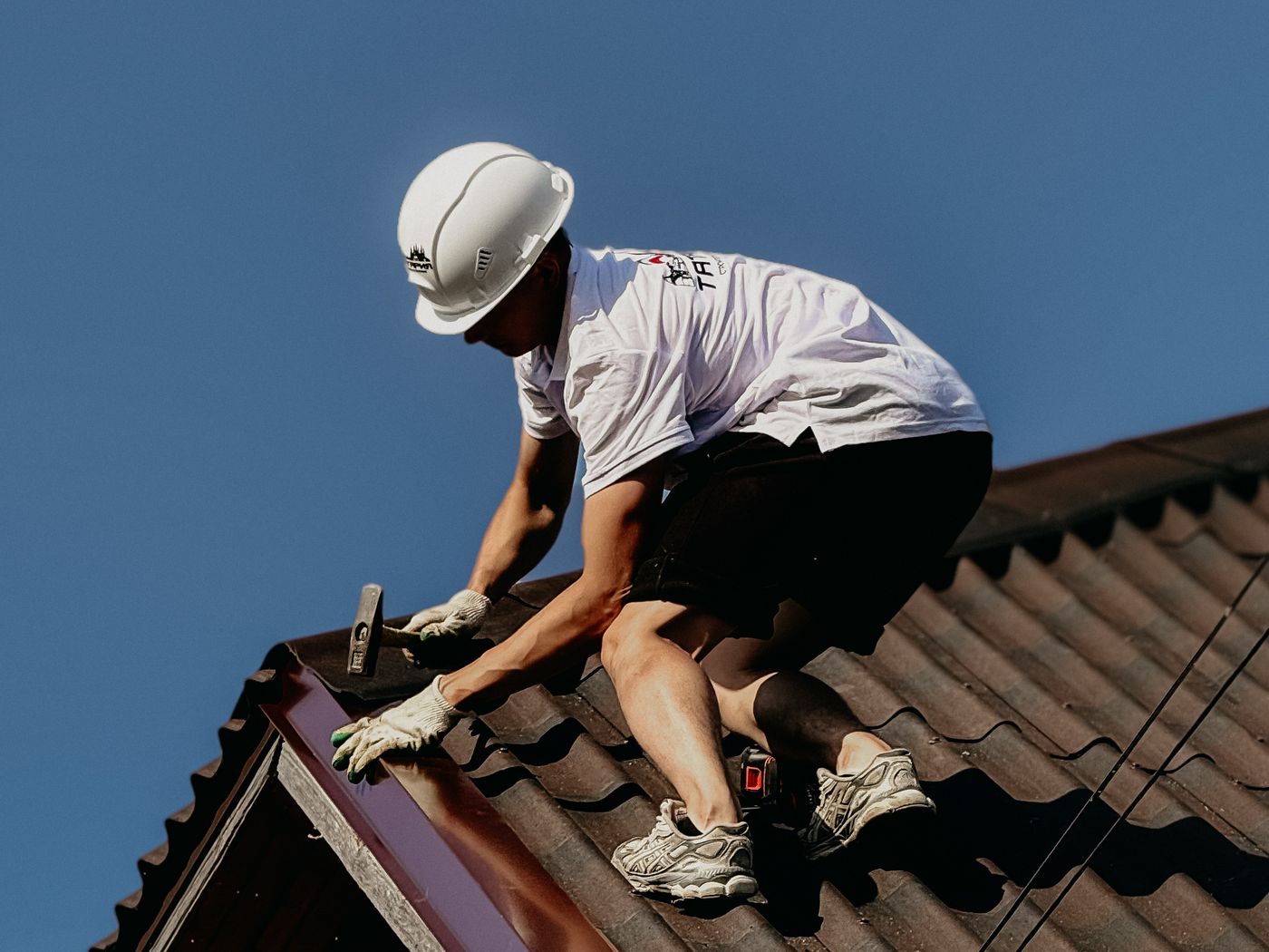 A roofer working on a pitched roof